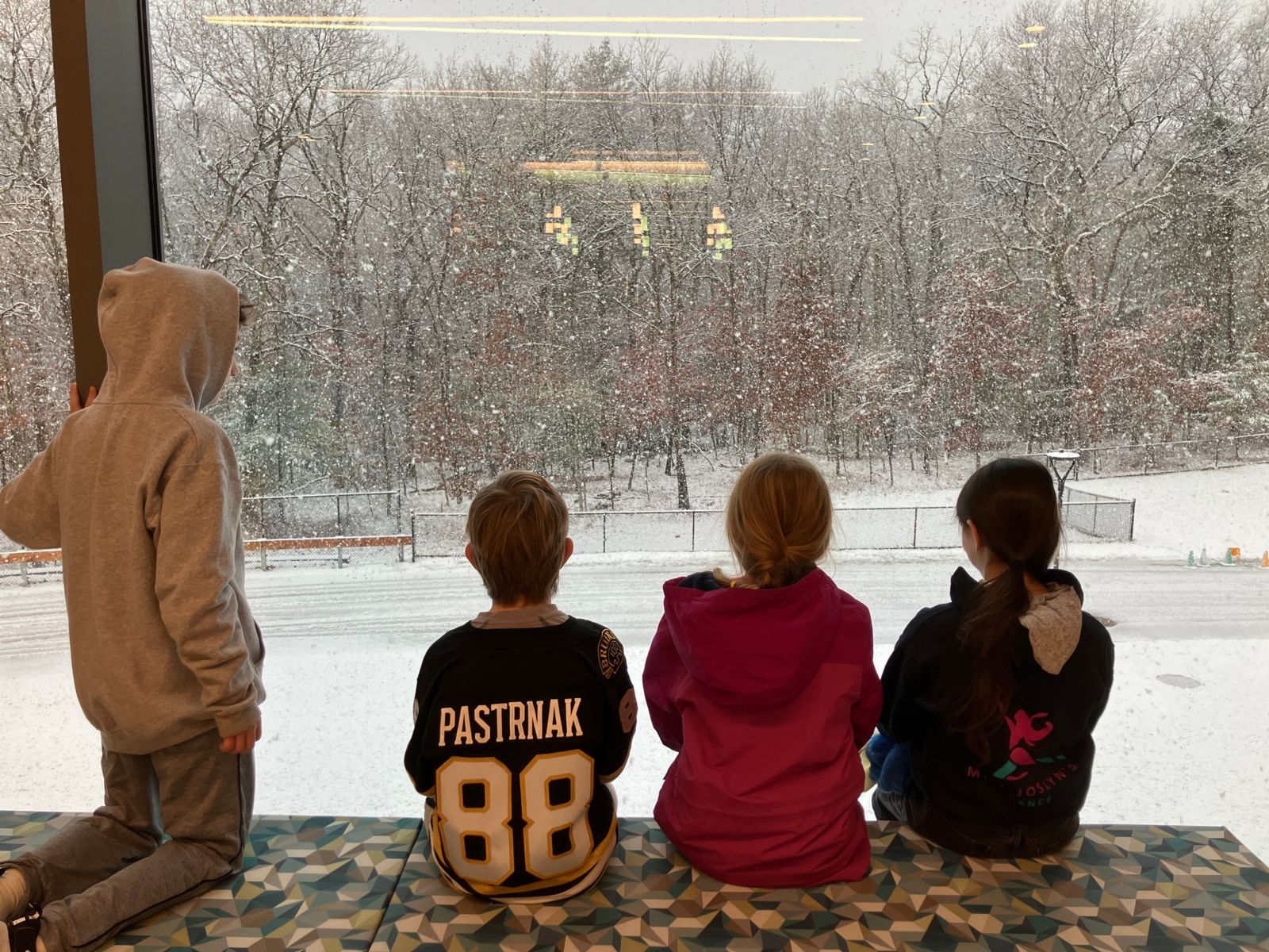 Four students viewing the season's first snow in December of 2024