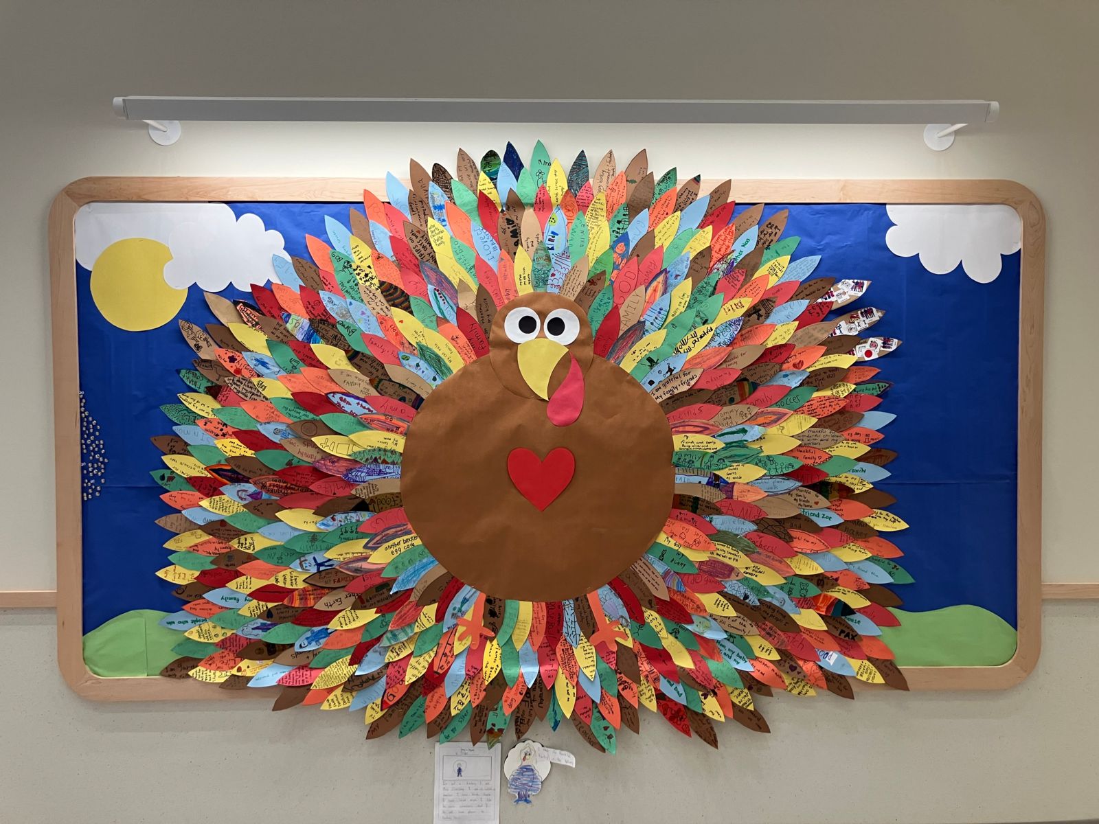 A giant, colorful turkey created by students displaying messages of thanks.