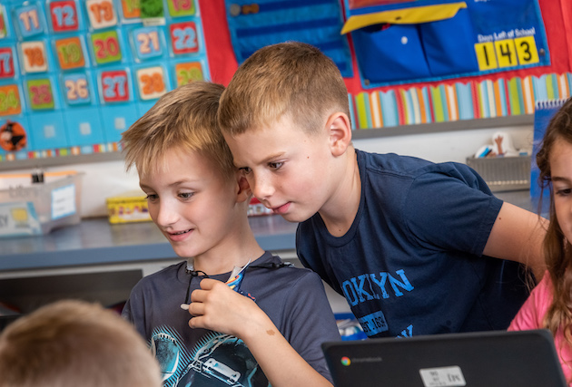 Two students looking at something