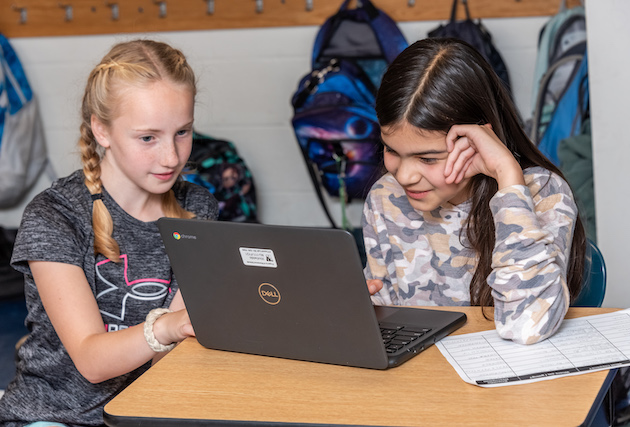 Two students looking a computer screen