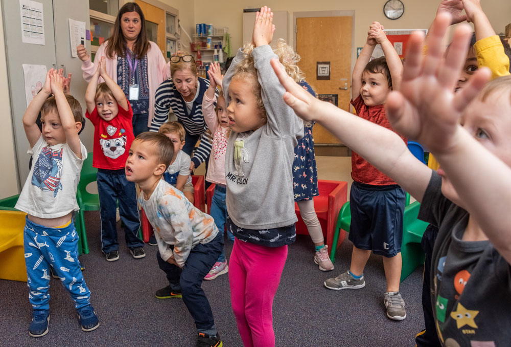 Preschool - group of students raising their arms - Fall 2022