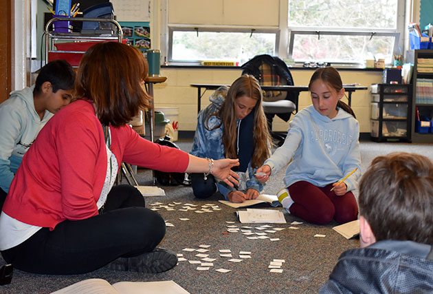 Students working with teacher