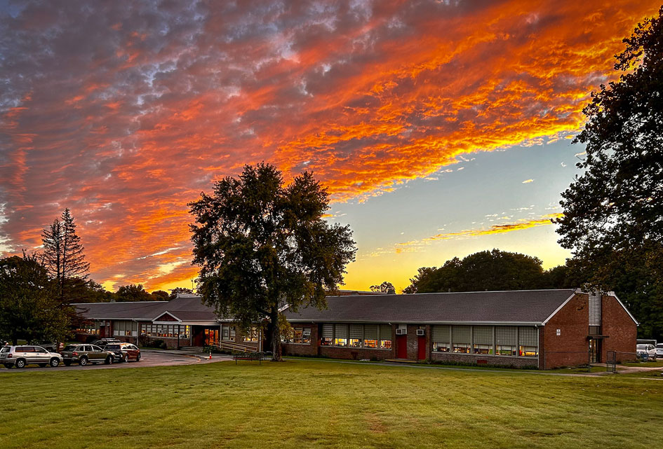 Orange , purple, and pink clouds above the Deerfield School