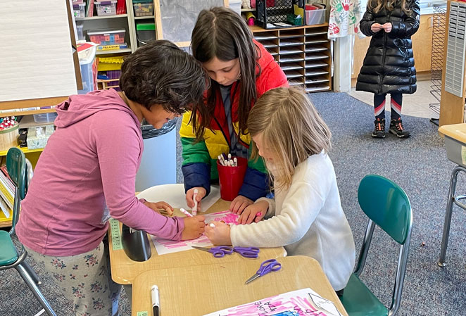 3 girls coloring together