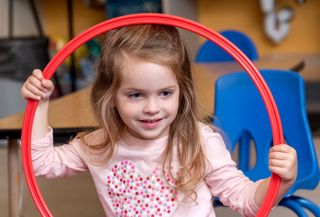 Preschool student holding a circle