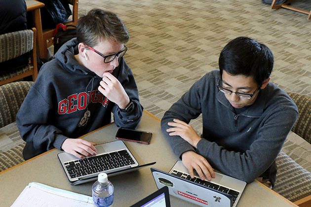 Students collaborating in library