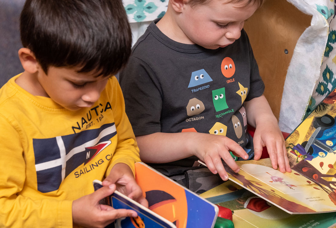 Preschool two boys reading books - Fall 2022